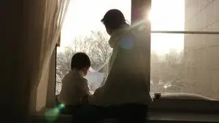 Mom and Son Sitting on the Big Window of the House in the Winter | Stock Footage - Videohive