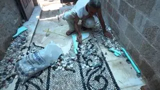 Traditional Greek pebblestone mosaic artist Stelios Grekos at work