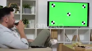 Man Drinking Tea and Watching TV with Green Screen at Home | Stock Footage - Envato elements