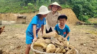 A single mother and her two sons clean and prepare a soccer field for their children. DANG THI DU
