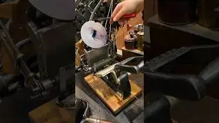 Using a tabletop printing press to print an image of a wooden printing press