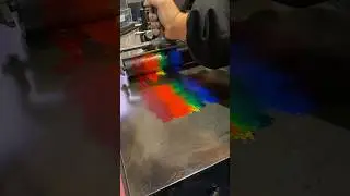 Rolling out 6 colors of ink with a large brayer for letterpress printing.