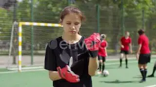 Young Female Soccer Player Putting On Goalkeeper Gloves | Stock Footage - Envato elements