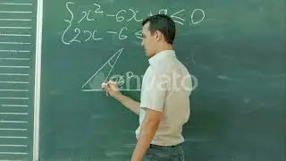 Young Male Teacher or Student Holding Chalk Writing on Chalkboard in Classroom | Stock Footage -...