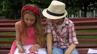 Little Girl Draws in the Album on the Bench | Stock Footage - Videohive